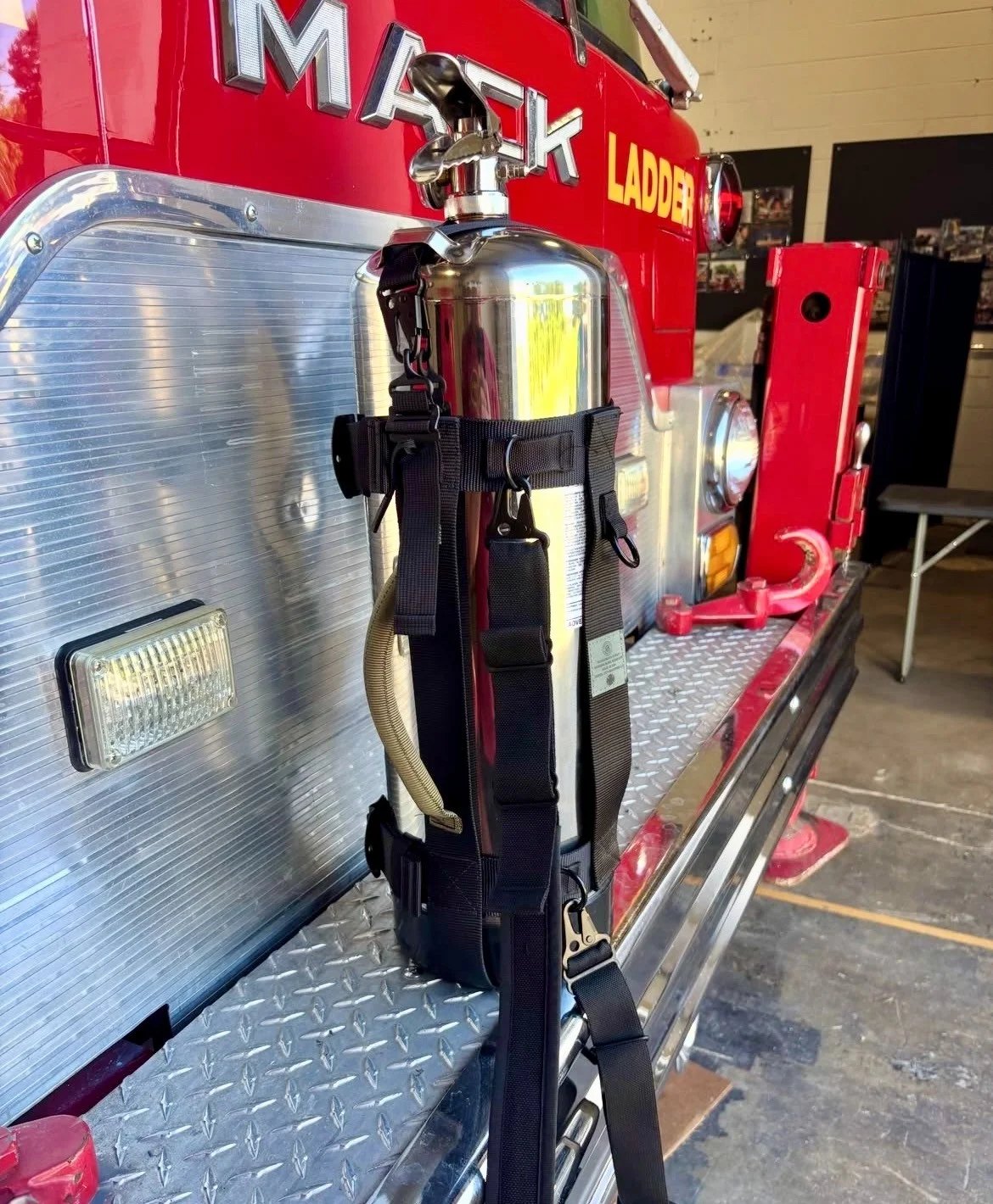 CCI radio strap carrying a stainless extinguisher on a Mack ladder truck